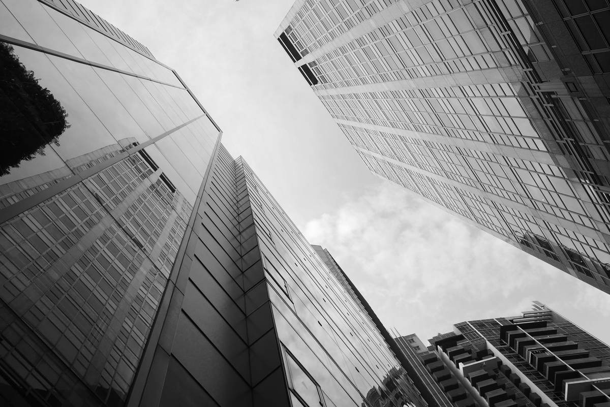 Corporate high-rise buildings reaching into a cloudy sky